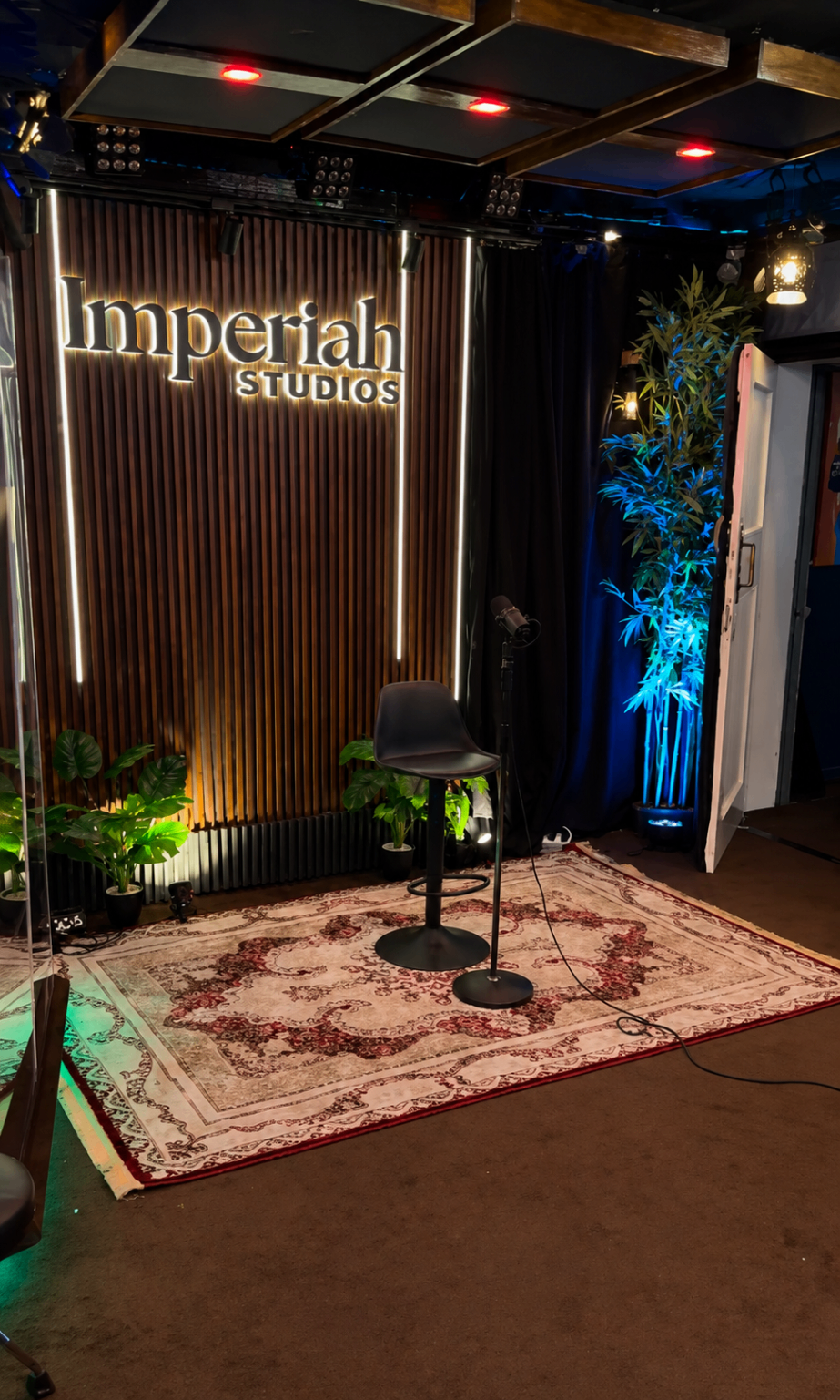 Performance corner with studio signage and vocal microphone